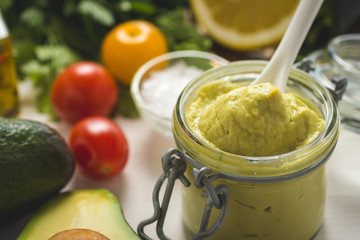 Homemade Green Avocado Spread in Jar. Vegan Raw and Healthy Fresh Food Concept.