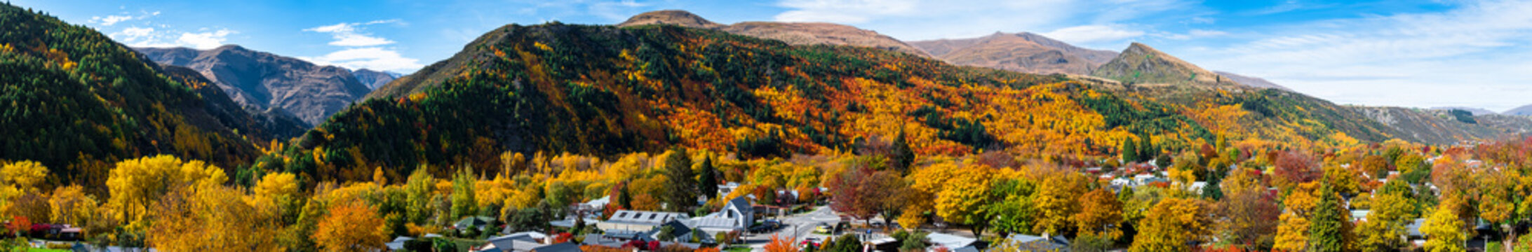 Panorama view of Arrowtown, New Zealand. Beautiful green yellow orange and red autumn trees with the town.