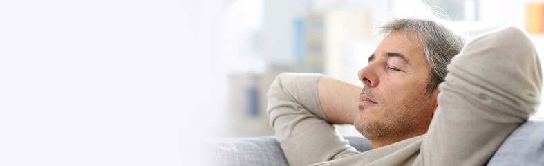 Obraz premium Man taking a nap in sofa at thome, template