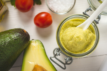 Homemade Green Avocado Spread in Jar. Vegan Raw and Healthy Fresh Food Concept.