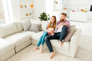 Day freetime chill two partners people ginger hair vacation concept. Cute sweet careless handsome beautiful excited cheerful lovers eating pop corn from basket watching favorite film in living room