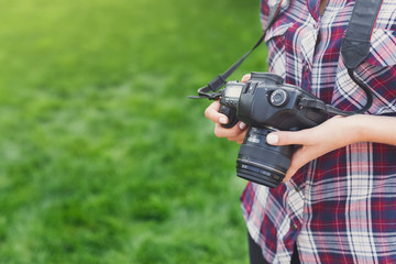 Unrecognizable young woman taking pictures outdoors