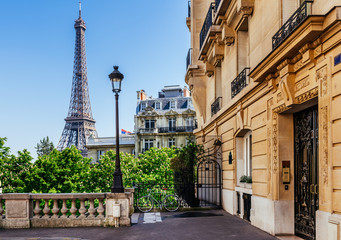 Cozy street with view of Paris Eiffel Tower in Paris, France. Eiffel Tower is one of the most...