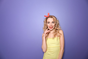 Portrait of beautiful young woman on color background