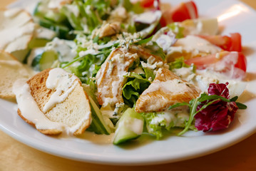 Delicious salad with grilled chiken and fresh vegetables, food background