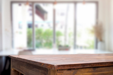 Selected focus empty brown wooden table and Coffee shop blur background with bokeh image. for your...