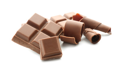 Pieces of chocolate and curls on white background