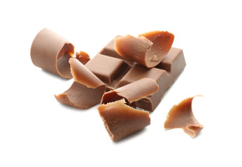 Piece of chocolate and curls on white background