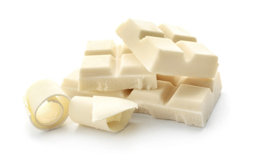 Pieces of chocolate and curls on white background