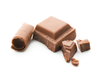 Pieces of chocolate and curls on white background