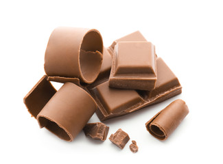 Pieces of chocolate and curls on white background