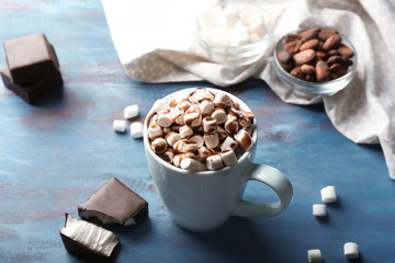 Cup of tasty cocoa drink with marshmallow on wooden table