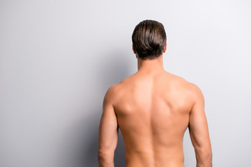 Rear back behind view photo of strong muscular handsome attractive stunning confident ideal perfect sportsman isolated on gray background copyspace