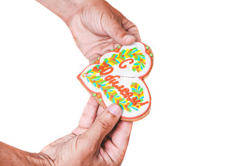 Hands break carrot in form of  heart