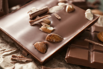Tasty milk chocolate with almonds, closeup