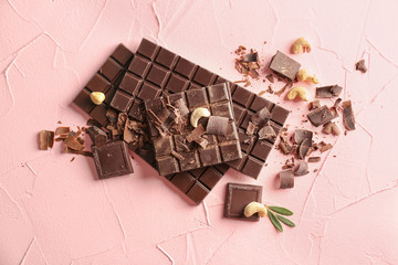 Tasty chocolate on color background