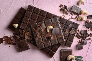 Chocolate with nuts on color textured background