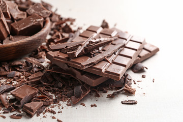 Pieces and bars of chocolate on table