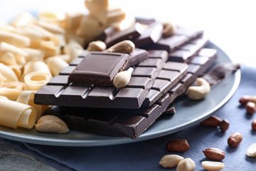 Plate with dark and white chocolate on table