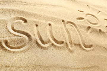 Fototapeta na wymiar Word SUN written on beach sand