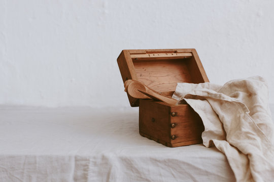 Wooden box with kitchen utensils and a linen napkin