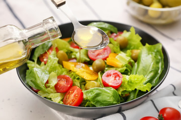 Dressing of fresh vegetable salad with olive oil