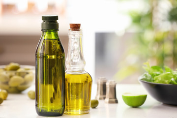 Bottles with olive oil on table