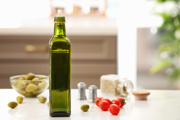 Bottle with olive oil on table