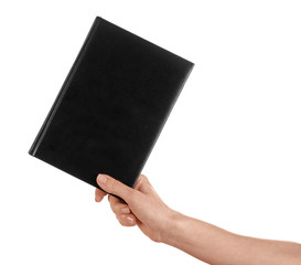 Female hand holding book with blank cover on white background