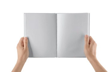 Female hands holding book with blank pages on white background