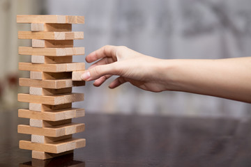 Tower from wooden blocks, Businesswoman Building Up Tower, Challenge In Business Concept, risk and strategy in business