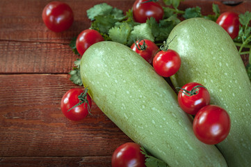 zucchini and tomatoes on.wooden background