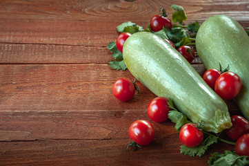zucchini and tomatoes on.wooden background
