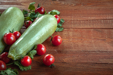 zucchini and tomatoes on.wooden background
