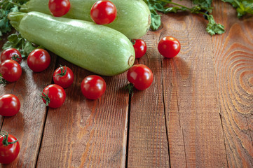 zucchini and tomatoes on.wooden background