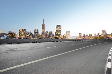 Fototapeta na wymiar empty asphalt road with modern city skyline