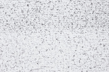 Grunge white felt texture background with black dust spraying, wrinkles and torn edges. Dirty damaged style, worn surface for design or web projects. Space for text. 