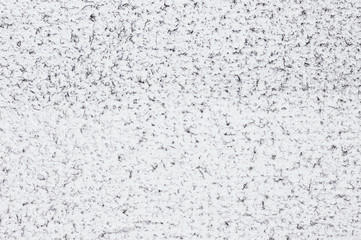 Grunge white felt texture background with black dust spraying, wrinkles and torn edges. Dirty damaged style, worn surface for design or web projects. Space for text. 