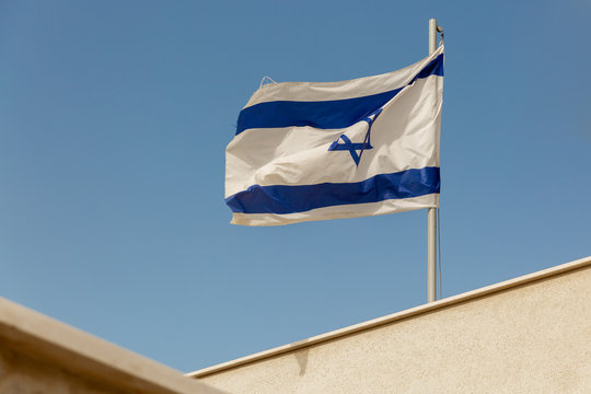 White and blue flag of Israel on roof