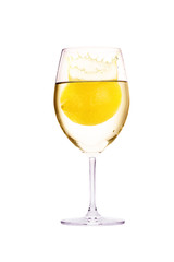 glass with water and lemon juice splashing isolated on a white background.