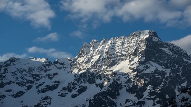 Morning light on the Sirac mountain peaks (Ecrins National Park) with passing clouds (time-lapse). Valgaudemar, Hautes-Alpes, European Alps, France