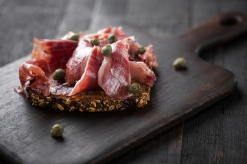 Traditional Spanish Jamon Serrano ham, Prosciutto Crudo, Parma ham, Italian antipasto, served on...