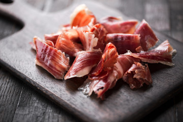 Traditional Spanish Jamon Serrano ham, Prosciutto Crudo, Parma ham, Italian antipasto. - obrazy, fototapety, plakaty