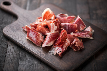 Traditional Spanish Jamon Serrano ham, Prosciutto Crudo, Parma ham, Italian antipasto. - obrazy, fototapety, plakaty