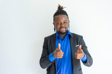 Successful hipster young black businessman making finger guns and pointing to camera. Content cool handsome African man in formalwear looking at camera. Choice concept