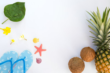 Tropical fruit composition with pineapple, coconuts, slippers, shells and starfish. Summer vacation background concept. top view,flat lay