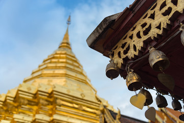 The golden bell ant the golden temple against with blue sky, "Wat Phra That Doi Suthep" One of the famous landmark of Chiang Mai, Thailand.