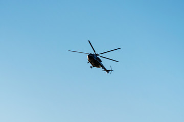 Fototapeta na wymiar helicopter in the air against the blue sky