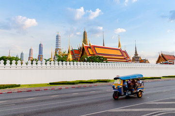 Wat Phra Kaew in Bangkok, Thailand and Tuk Tuk is on the road : Temple of the Emerald Buddha. Wat Phra Kaew is among the best known of Thailand's landmarks