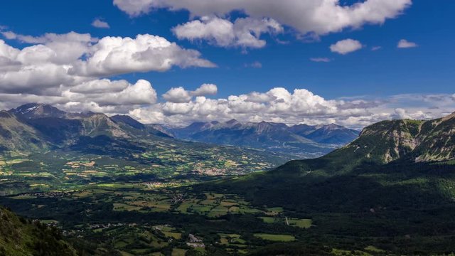 Champsaur Valley with the Village of Saint-Bonnet  in Summer with passing clouds (time-lapse). Hautes-Alpes, Drac Valley, Ecrins National Park, Alps, France